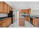 Well-lit kitchen features an island, stainless steel appliances and wood cabinets at 211 Whitney Ln, Durham, NC 27713