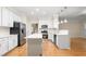 Bright kitchen featuring white cabinetry, stainless steel appliances, and an island with a breakfast bar at 211 Whitney Ln, Durham, NC 27713