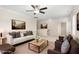 Comfortable living room area with neutral-toned furniture, a ceiling fan, and ample natural light at 211 Whitney Ln, Durham, NC 27713