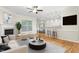 Comfortable living area with fireplace, neutral furnishings, and seamless flow into the dining area at 211 Whitney Ln, Durham, NC 27713