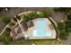 Aerial view of a community pool with neat landscaping, ample lounge chairs, and a parking area at 211 Whitney Ln, Durham, NC 27713