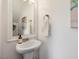 Bathroom with pedestal sink, mirror, and a towel holder at 233 Breezemont Dr, Fuquay Varina, NC 27526