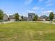 Neighborhood common area featuring a large grass field surrounded by attractive modern homes at 233 Breezemont Dr, Fuquay Varina, NC 27526