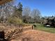A brick patio overlooks a lush backyard with mature trees and landscaping at 30 Brookside Place, Durham, NC 27705