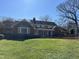Spacious backyard featuring a brick patio with retaining wall and steps leading up to a large lawn at 30 Brookside Place, Durham, NC 27705