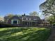 Expansive backyard with lush green lawn, brick patio, and beautiful architectural details at 30 Brookside Place, Durham, NC 27705