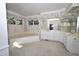 Large primary bathroom with a sunken tub, dual sinks, and plenty of light at 30 Brookside Place, Durham, NC 27705