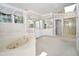 Primary bathroom with a large soaking tub, dual sinks, and a separate shower at 30 Brookside Place, Durham, NC 27705