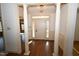 Elegant entryway with hardwood floors, white columns, wainscoting, and transom window above the door at 30 Brookside Place, Durham, NC 27705