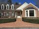 Charming brick home with dormer windows and well-manicured landscaping at 30 Brookside Place, Durham, NC 27705