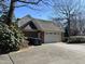 Attached two-car garage with a paved driveway at 30 Brookside Place, Durham, NC 27705