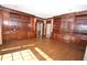 Spacious living room with hardwood floors, wooden built-in shelves and cabinets, and natural light at 30 Brookside Place, Durham, NC 27705