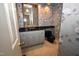 Charming powder room with floral wallpaper, black countertop and toilet, and elegant mirror at 30 Brookside Place, Durham, NC 27705