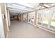 Spacious sunroom with tile flooring, glass doors and windows, connects to the kitchen for seamless living at 30 Brookside Place, Durham, NC 27705