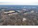 Aerial view of extensive wooded acreage in a suburban location at 3120 Timberlyne Dr, Mebane, NC 27302