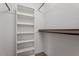 Walk-in closet with shelves and rods at 3120 Timberlyne Dr, Mebane, NC 27302