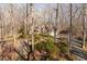 View of the home's exterior showcasing a brick facade and lush landscaping at 3120 Timberlyne Dr, Mebane, NC 27302