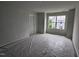 Neutral bedroom showcasing a new window and door, with flooring covered for protection at 332 Chesapeak Commons St # 141, Garner, NC 27529