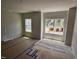Bright bedroom with large windows and newly painted walls, flooring covered for protection at 332 Chesapeak Commons St # 141, Garner, NC 27529