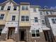 New townhomes with brick accents and large windows under construction, showcasing modern design at 332 Chesapeak Commons St # 141, Garner, NC 27529