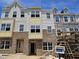 New townhome features brick facade and multiple windows under a bright blue sky at 332 Chesapeak Commons St # 141, Garner, NC 27529