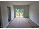 Spacious living room with sliding glass doors to a deck and neutral colored walls and flooring covered for protection at 332 Chesapeak Commons St # 141, Garner, NC 27529
