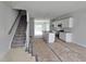 Open concept kitchen and living area showcasing modern design and neutral finishes, flooring covered for protection at 332 Chesapeak Commons St # 141, Garner, NC 27529