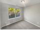 Clean bedroom featuring neutral walls, carpet, and a large window with an outside view at 360 Red Elm Dr, Durham, NC 27713