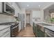 Well-equipped kitchen with stainless steel appliances and white cabinetry at 401 Shadow Falls Dr, Wendell, NC 27591