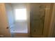 Bathroom featuring a tub with a window view and a glass-enclosed shower at 405 Ganyard Farm Way, Durham, NC 27703