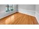 Light and airy bedroom with hardwood floors and a large window at 405 Ganyard Farm Way, Durham, NC 27703