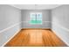 Bright dining room with hardwood floors, classic chandelier, and large window at 405 Ganyard Farm Way, Durham, NC 27703