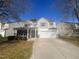 Charming two-story home featuring neutral siding, inviting front porch, and attached two-car garage at 405 Ganyard Farm Way, Durham, NC 27703