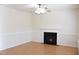 Comfortable living room featuring a fireplace, neutral walls, hardwood floors, and an overhead ceiling fan at 410 Henry Cir, Sanford, NC 27330