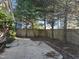 Backyard featuring a concrete patio area, privacy fence, and mature trees at 4300 Mantua Way, Raleigh, NC 27604