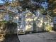A quaint backyard featuring a concrete patio and a charming entrance with white stairs at 4300 Mantua Way, Raleigh, NC 27604