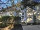 A quaint backyard featuring a concrete patio and a charming entrance with white stairs at 4300 Mantua Way, Raleigh, NC 27604