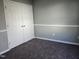 Bedroom with a closet featuring double doors, neutral paint, and plush carpeting at 4300 Mantua Way, Raleigh, NC 27604