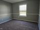 Inviting bedroom with a neutral color palette, wainscotting and large window enhancing the ambiance at 4300 Mantua Way, Raleigh, NC 27604