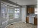 Sunny breakfast nook with bay window, light fixture, tile flooring, and doorway to kitchen at 4300 Mantua Way, Raleigh, NC 27604