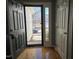 Inviting entryway with hardwood floors, a sidelight window, and an open view to the outdoors at 4300 Mantua Way, Raleigh, NC 27604