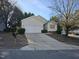 Attractive home with a spacious driveway leading to a two-car garage and a well-kept lawn at 4300 Mantua Way, Raleigh, NC 27604