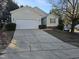 Desirable single-Gathering home featuring a two-car garage, long driveway, and manicured front yard at 4300 Mantua Way, Raleigh, NC 27604
