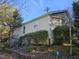 Side exterior of home shows upper and lower windows plus shrubbery near stone retaining wall at 4300 Mantua Way, Raleigh, NC 27604