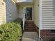 Inviting front porch with brick steps, white railing and a storm door perfect for welcoming guests at 4300 Mantua Way, Raleigh, NC 27604