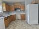 Functional kitchen with wood cabinets, white appliances, and laminate countertops at 4300 Mantua Way, Raleigh, NC 27604