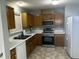 Traditional kitchen featuring wooden cabinets, stainless steel appliances, and durable countertops at 4300 Mantua Way, Raleigh, NC 27604