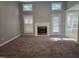 Spacious living room features a fireplace, multiple windows, neutral carpeting, and gray paint at 4300 Mantua Way, Raleigh, NC 27604