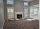 Cozy living room with fireplace, windows, and gray walls with doorway to breakfast nook at 4300 Mantua Way, Raleigh, NC 27604