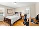 Bedroom with hardwood floors, white walls, and an attached bathroom at 4409 Driftwood Dr, Raleigh, NC 27606